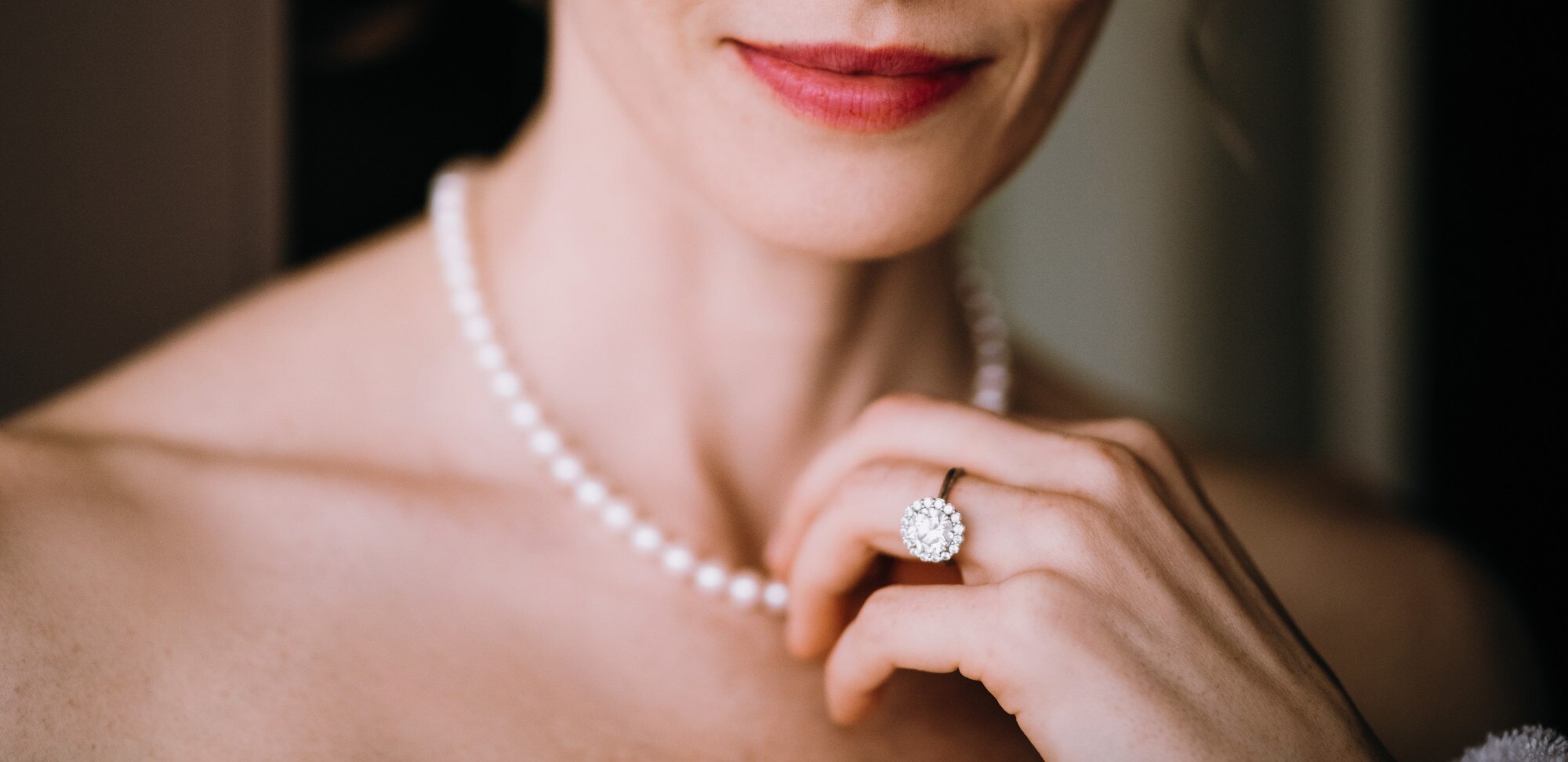woman-touches-tender-pearl-necklace-her-neck_8353-8844